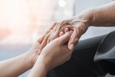 young hands holding older hands 